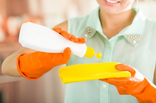 Cleaner preparing a Fulham property for new tenants with thorough dust removal
